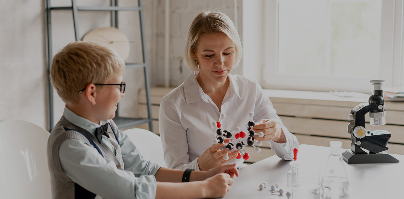 Female science tutor in Kissimmee studying chemistry with student